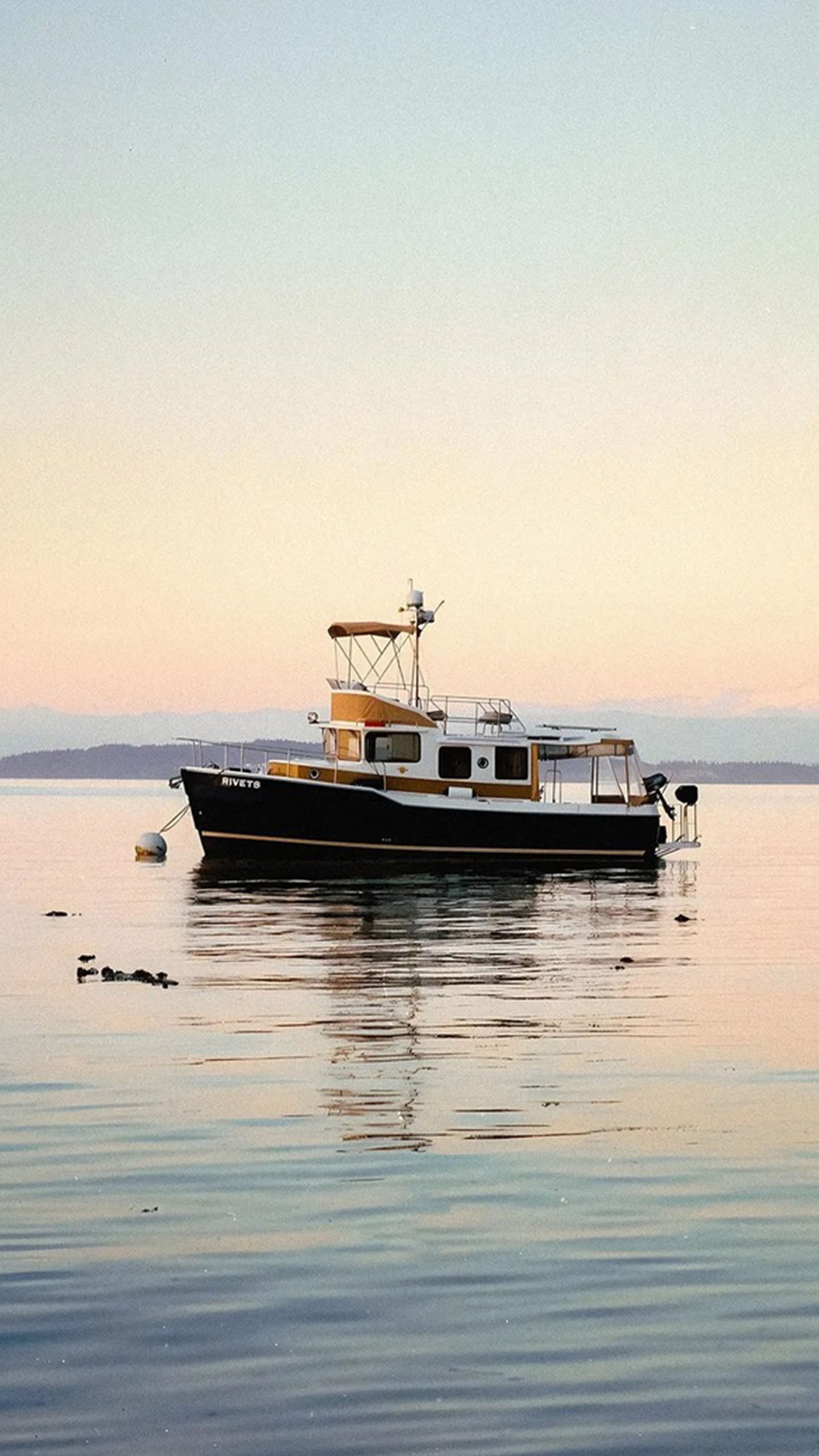 Sunset Glow on the Water: This Boat Floating in Pastel Skies Feels Like a Calm Dream!
